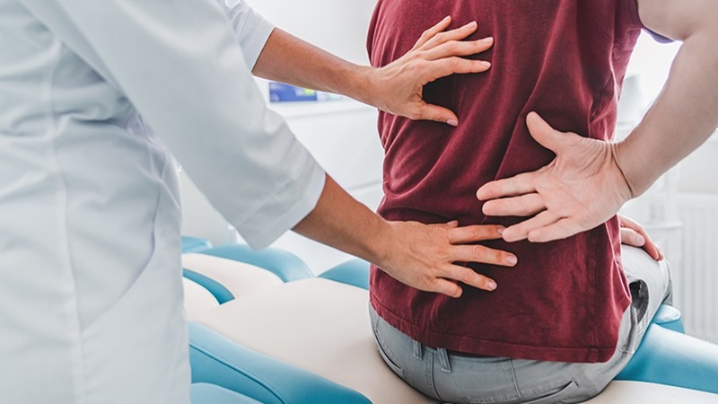 Bác sĩ thăm khám lâm sàng cho bệnh nhân đau lưng